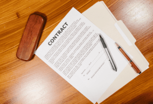 A contract on a desk with pens